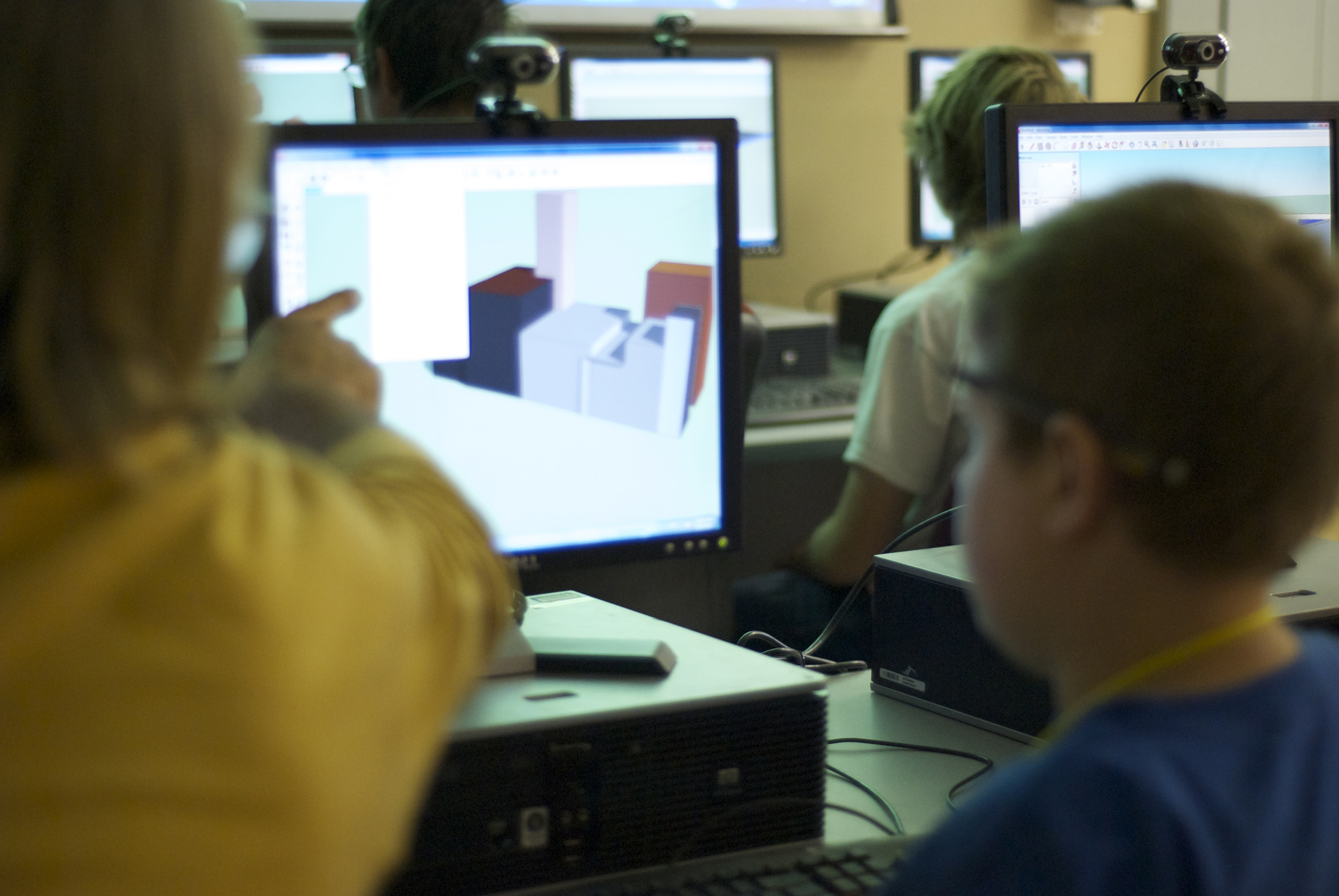 An iSTAR instructor shows a child how to use a feature on the 3-D modeling software SketchUp Make. iSTAR teaches the software to kids on the autism spectrum to help them build professional and social skills.