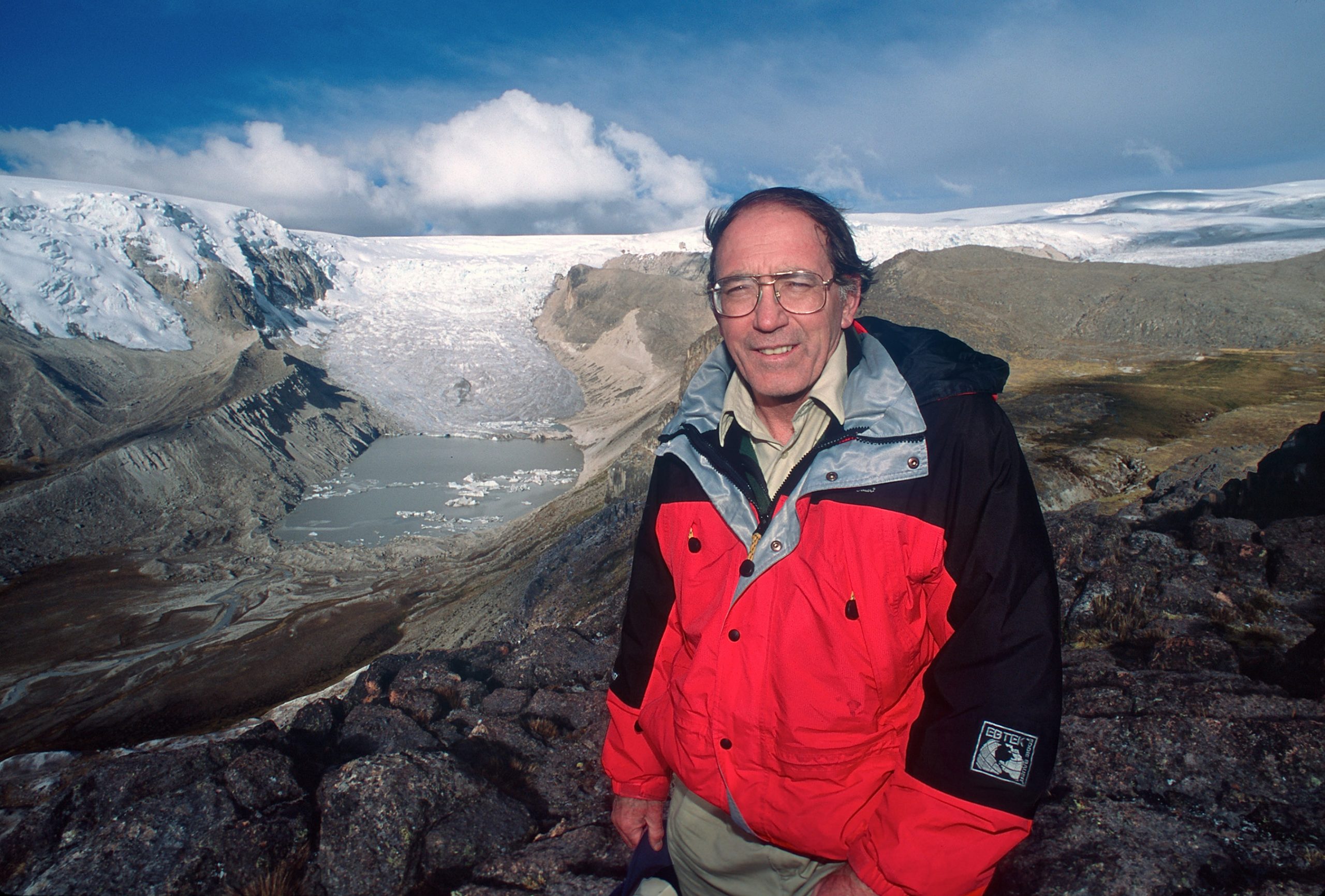 Lonnie Thompson, a scientist with the Byrd Polar Research Center, is shown here in 2000 with Peru's Qori Kalis Glacier in the background. Qori Kalis is the largest outlet glacier from the Quelccaya Ice Cap in the southern Andes of Peru. Thompson will deliver a Frontiers of Science lecture about glaciers, icecaps and climate change on April 14 at the University of Utah.